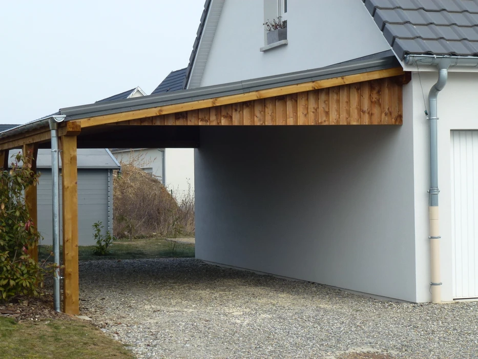 Terrasse extérieure moderne en dallage imitation bois, adjacente à une villa contemporaine à façade enduite claire