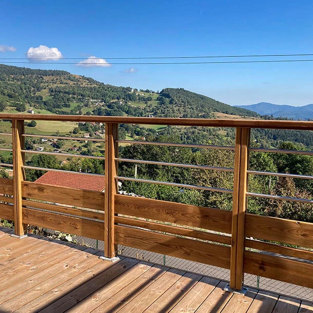 Piscine ronde enterrée sur terrasse extérieure surélevée, vue panoramique sur montagnes enneigées