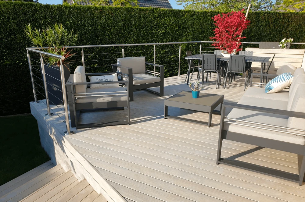 Piscine ronde enterrée sur terrasse extérieure surélevée, vue panoramique sur montagnes enneigées
